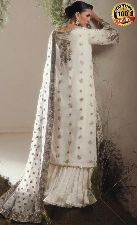 Embroidered white sharara suit for wedding guests with patchwork and traditional detailing
