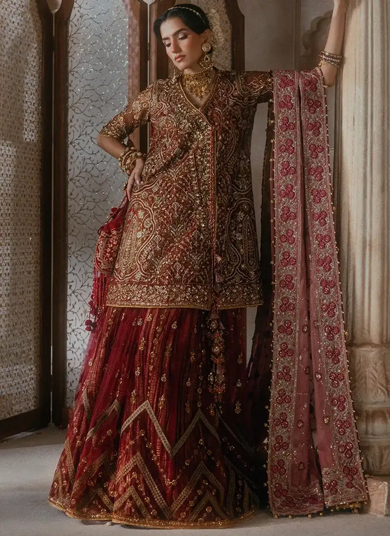 Dark green salwar kameez featuring embroidered medium silk sleeves and embellished sleeve borders