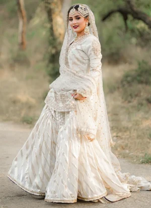 Ivory bridal gharara with V-neck Sheesha silk kameez, Brocia gharara, organza dupatta and gold and rose-gold embroidery