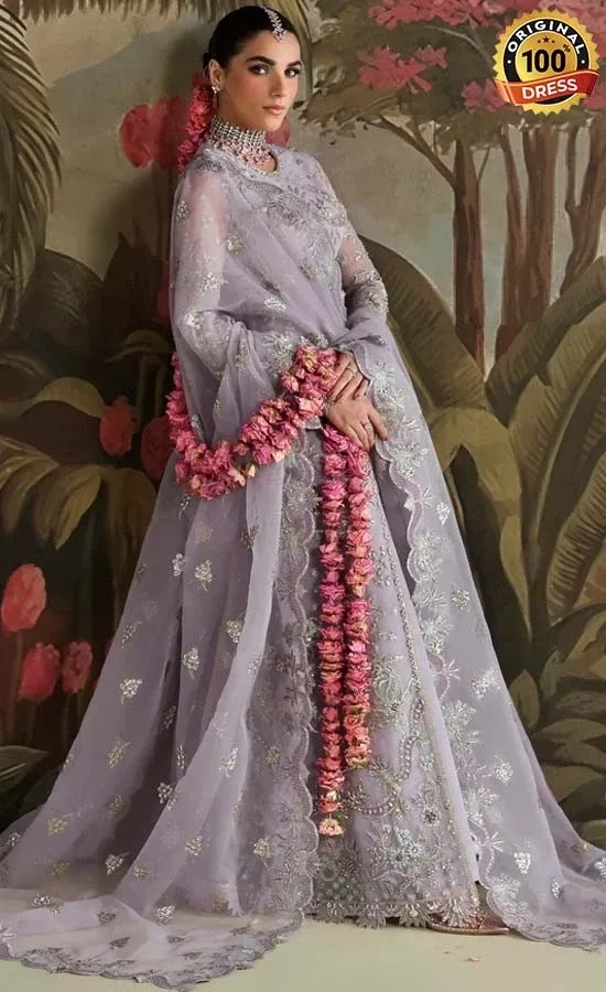 Pakistani lilac maxi dress for wedding guests with intricate embroidery and graceful styling