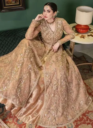 Apricot colour bridal gown in net worn over an American Katan silk lehenga with organza dupatta.