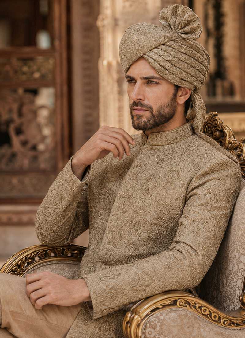 Close-up of beige embroidered groom sherwani with matching traditional turban
