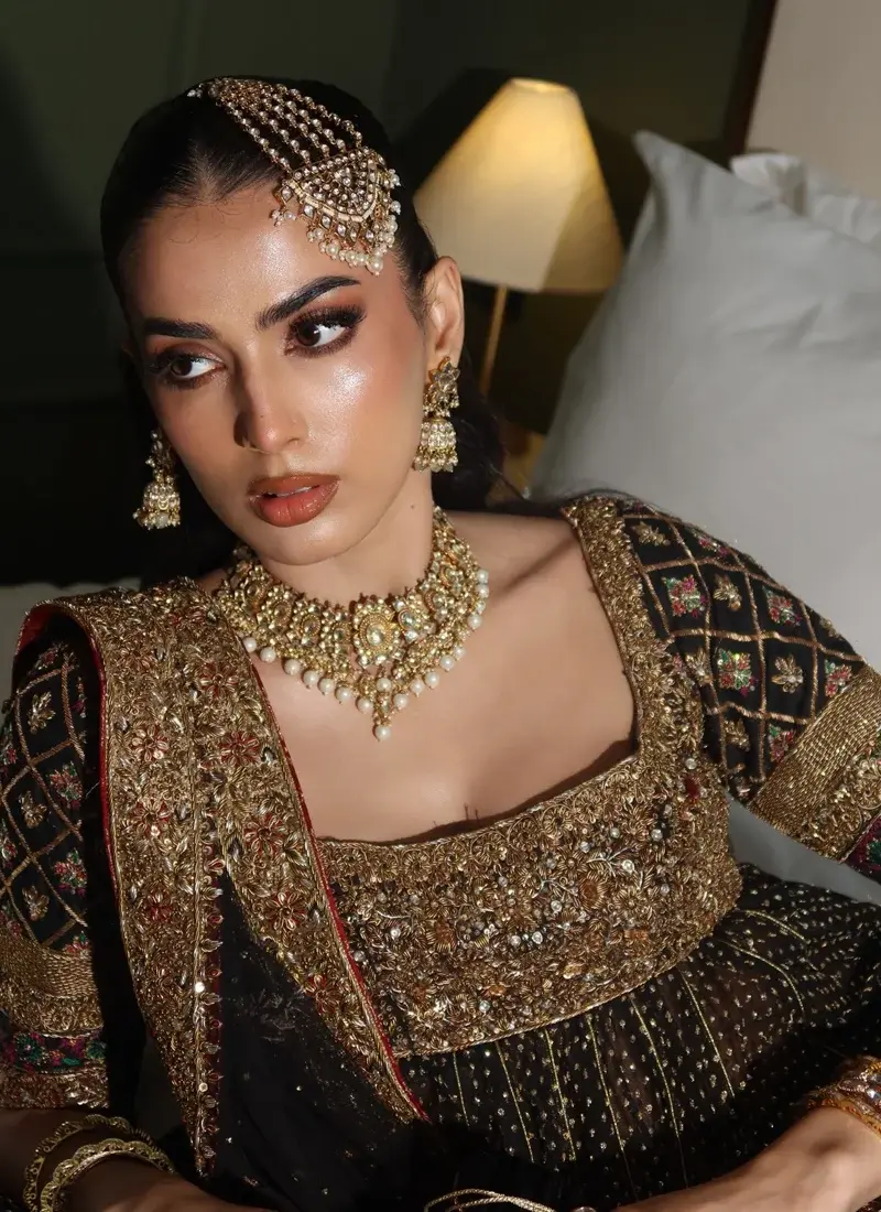 Black and gold bridal Pishwas featuring an embellished bodice and detailed multicolour sleeves