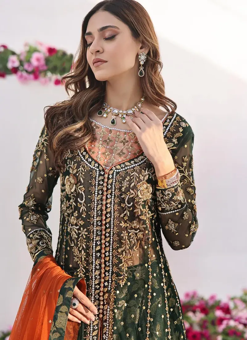Pakistani formal bottle green gown with Dhaka pajama and contrasting burnt orange dupatta