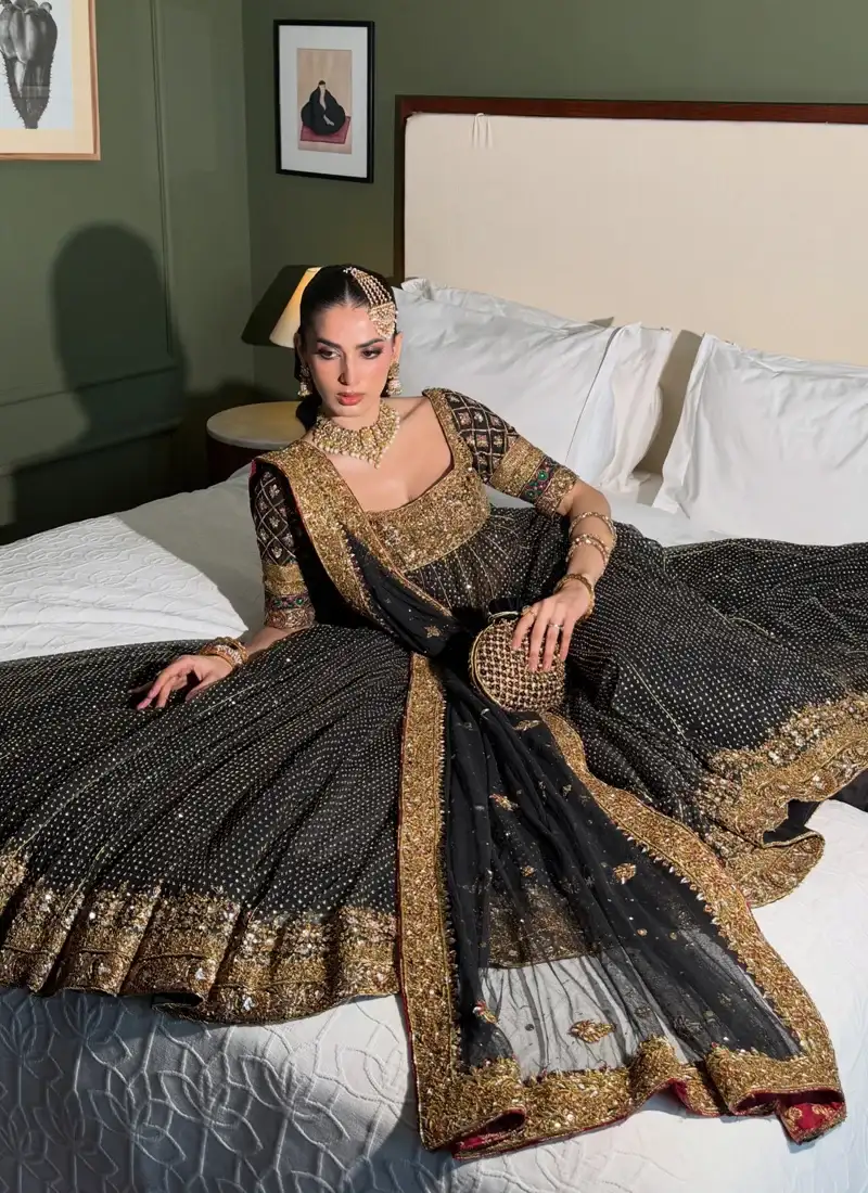 Pakistani bridal Kalidar Pishwas in black and gold with ornate multicolour sleeves and formal styling