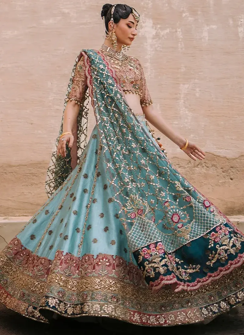 Aqua Mehndi Lehenga Choli with Scalloped Lotus Border Aqua mehndi lehenga choli back view with multicoloured tassel ties and a sheer teal floral lattice dupatta