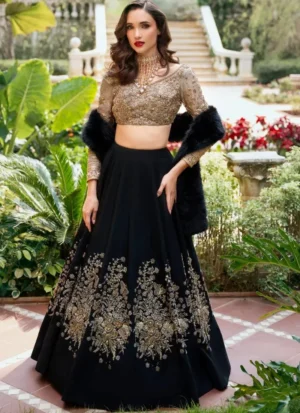 Black and gold bridal lehenga choli front view with floral skirt embroidery and black faux-fur stole