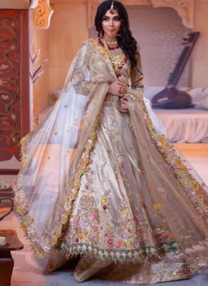 Champagne Walima lehenga choli, seated front view with embroidered peacock arches and teal beaded hem.