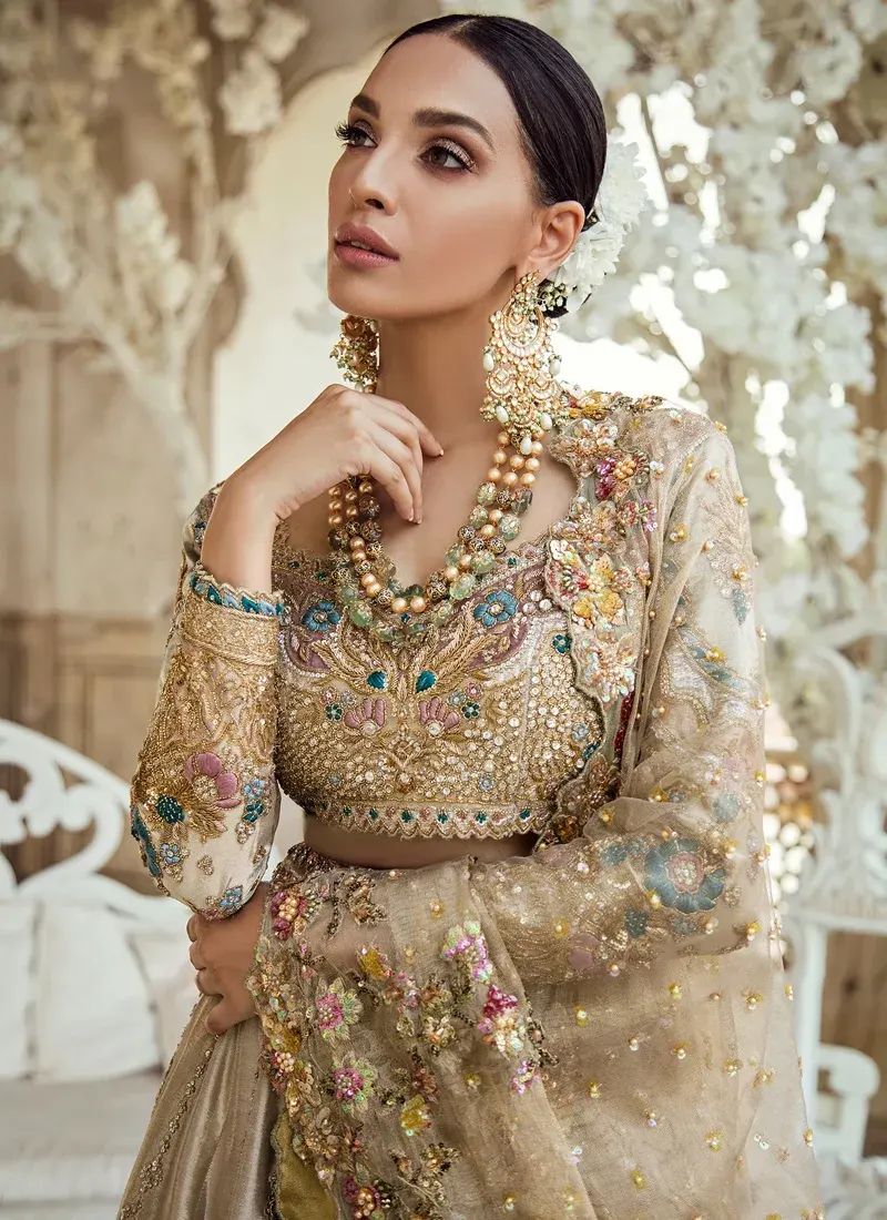 Champagne Walima Lehenga Choli with Scalloped Teal Hem Champagne bridal lehenga choli close-up with antique gold embroidery, teal floral motifs and sheer dupatta