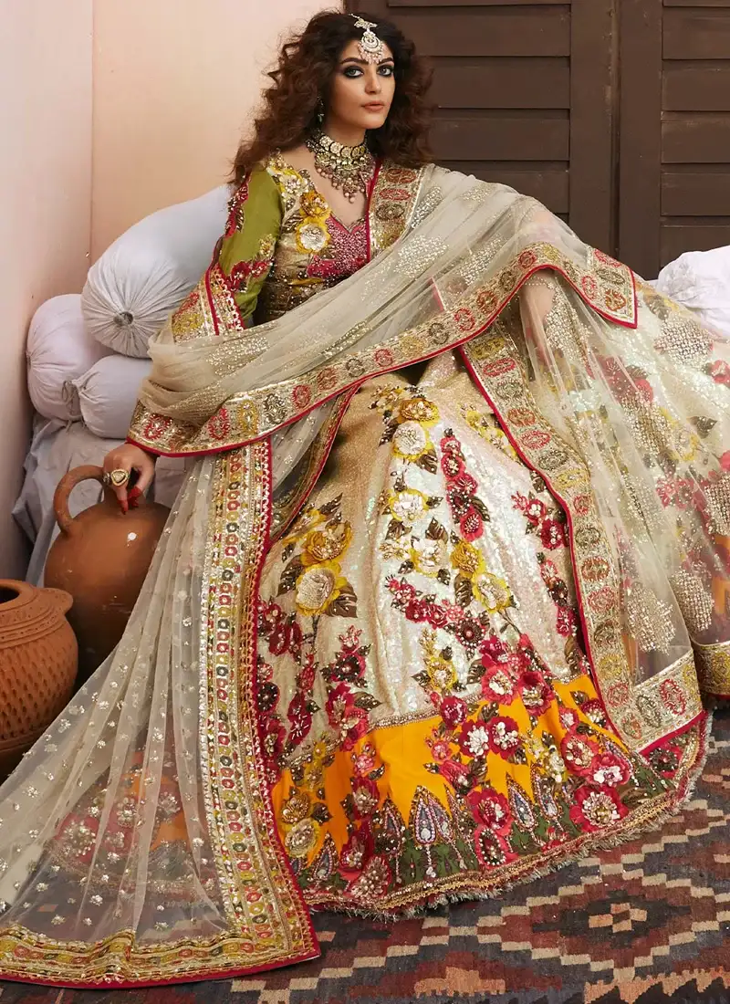 Ivory bridal choli close-up with scalloped V neckline, olive sleeves and multicolour floral beadwork
