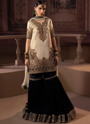 Ivory and black gharara suit, full front view, with gold embroidery and paisley borders on the flared hem