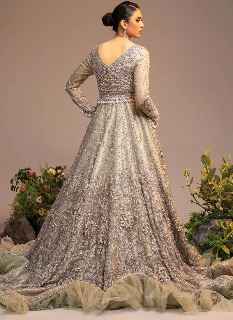 Ivory bridal gown bodice close-up with a beaded V-neck, silver crystal florals and embroidered sleeve cuffs.
