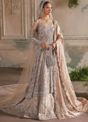 Peach bridal farshi lehenga side view beneath a sheer net veil with a wide embroidered border