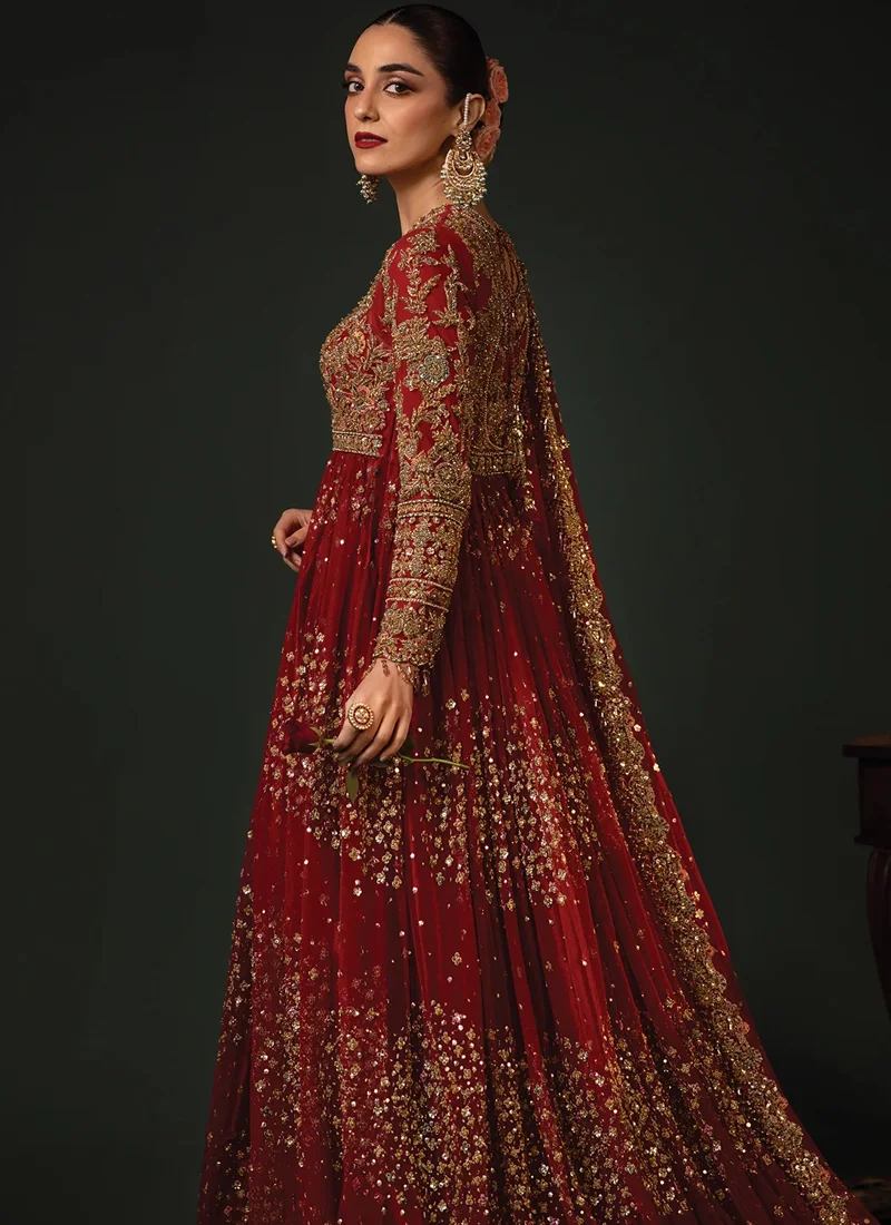 Red bridal pishwas full-length view with sheer gold-dotted dupatta and scalloped embroidered hem