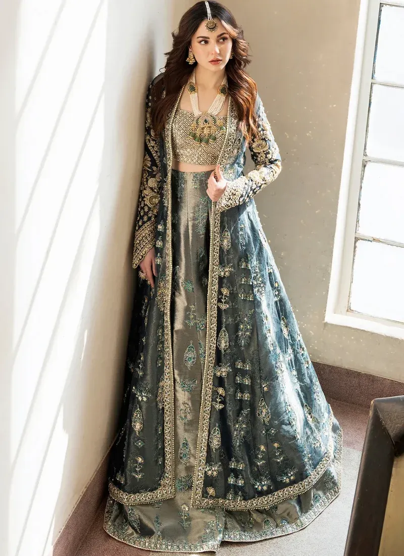 Teal Engagement Lehenga Choli with Floral Jacket Overlay Teal lehenga choli front close-up showing a gold crystal-studded bustier and richly embroidered jacket